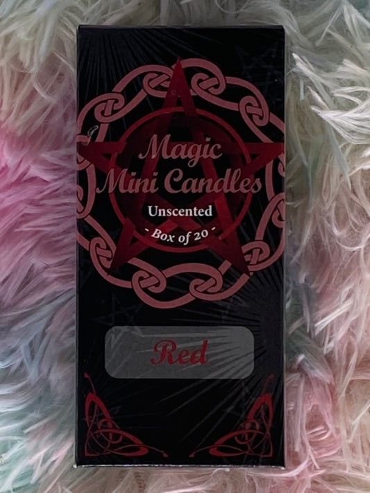 Box of "Magic Mini Candles" in red, featuring a pentagram and Celtic knot design on the packaging. The label indicates the candles are unscented and come in a box of 20. The box rests on a soft, pastel-colored fur background.